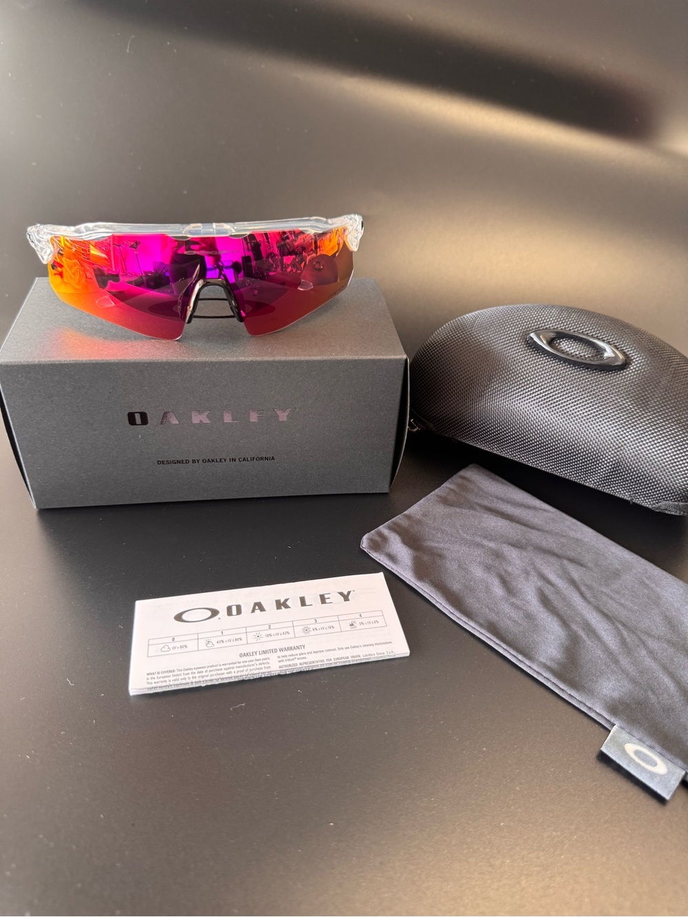 Oakley Clear Frame Sunglasses with Pink-Orange Mirrored Lens